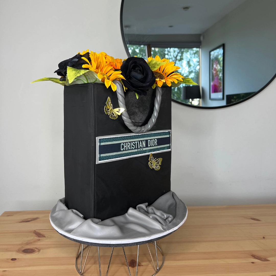 Black Christian Dior shopping bag cake with flowers