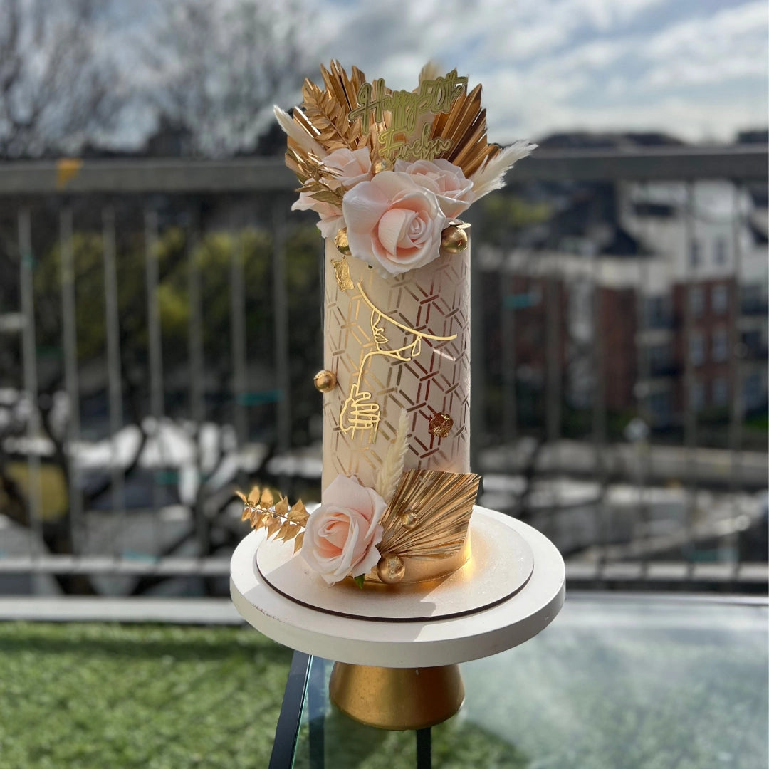 IVORY AND PEACH ELEGANT CAKE WITH GOLD PALM SPEARS AND FLOWERS