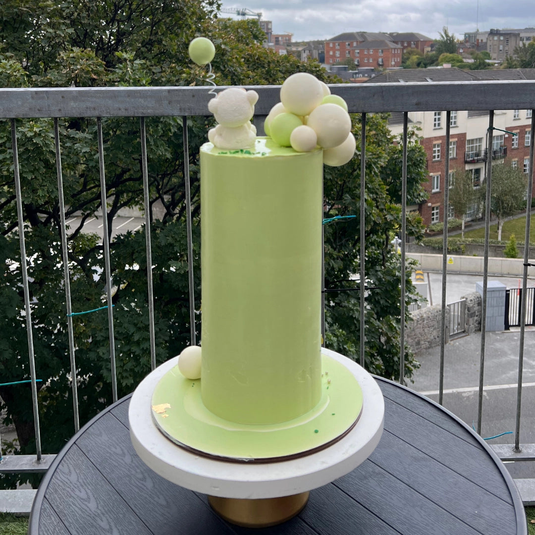 Tall lime green baby shower cake with teddy bears