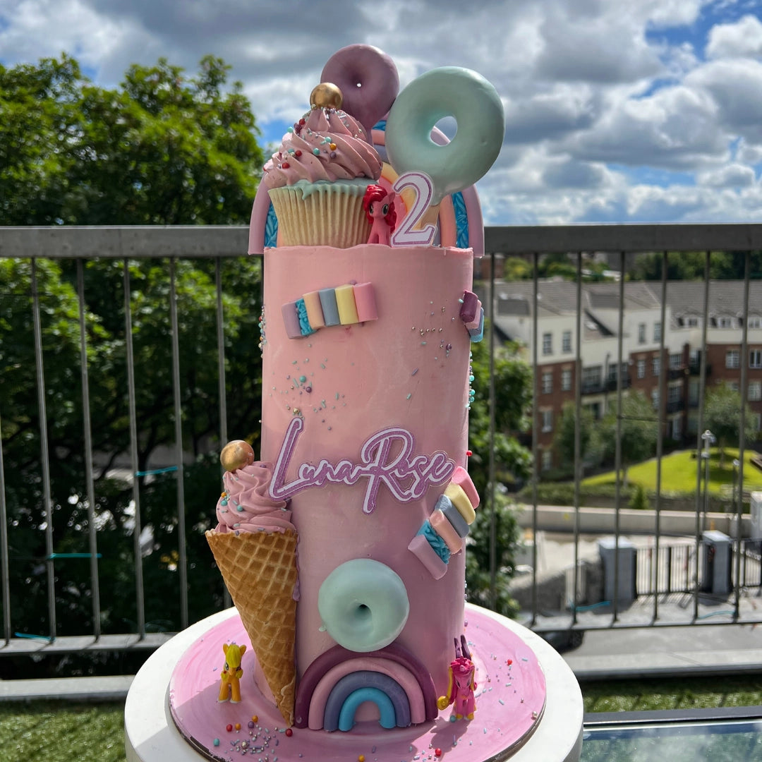Pink candy cake With cupcakes,cream,donuts
