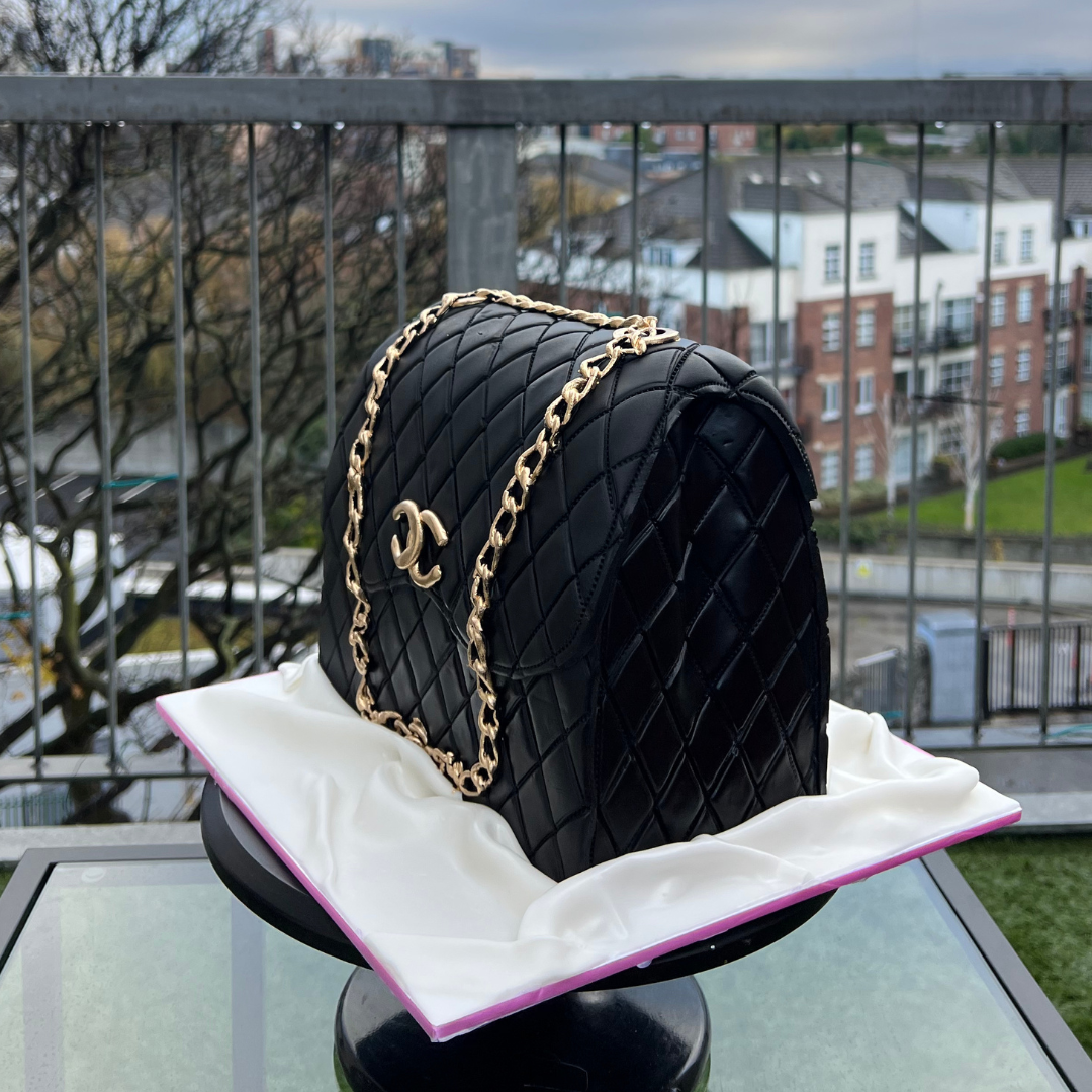 Custom Chanel handbag cake with realistic quilted fondant texture and gold chain detailing.