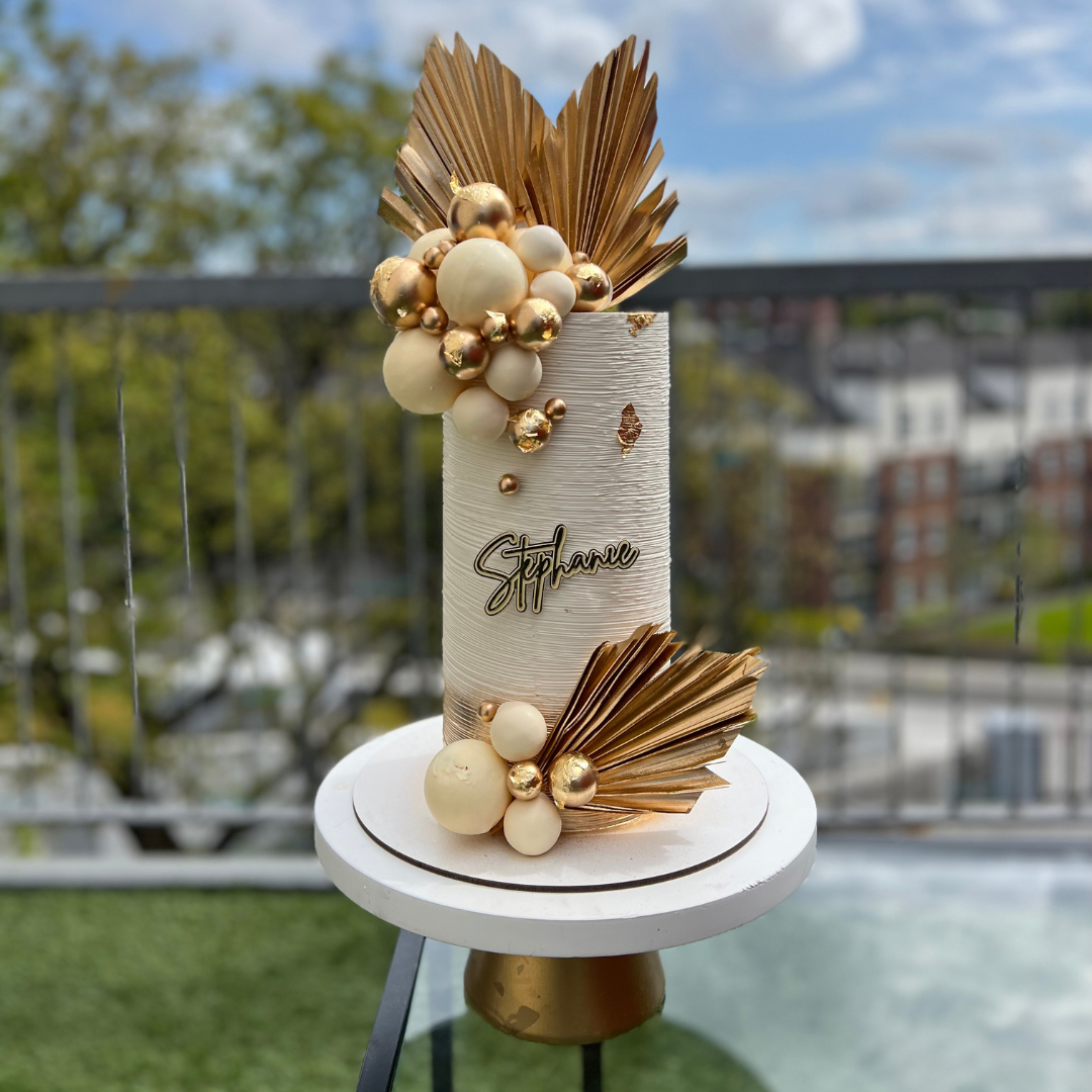 extra tall elegant white and gold birthday Cake