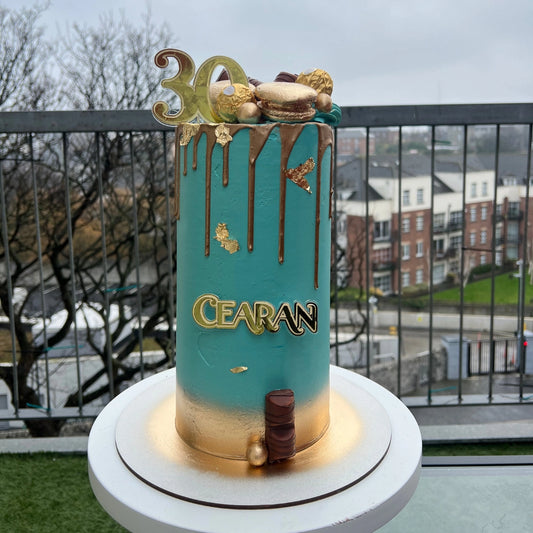 30TH TEAL AND GOLD CAKE WITH DRIP AND MACAROONS