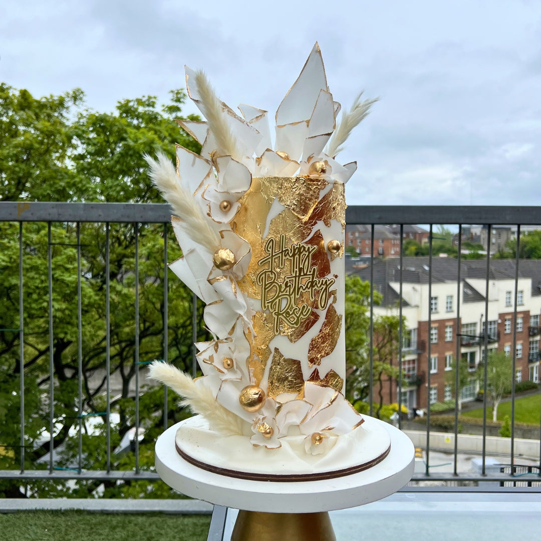 White and gold wafer paper celebration cake with sculptural sails and personalised gold topper, Dublin