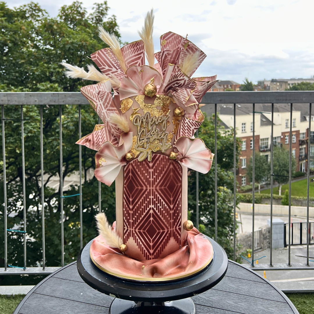 Blush and copper wafer paper cake with geometric stencil work, gold leaf and pampas grass, handmade in Dublin by CakeMeAway