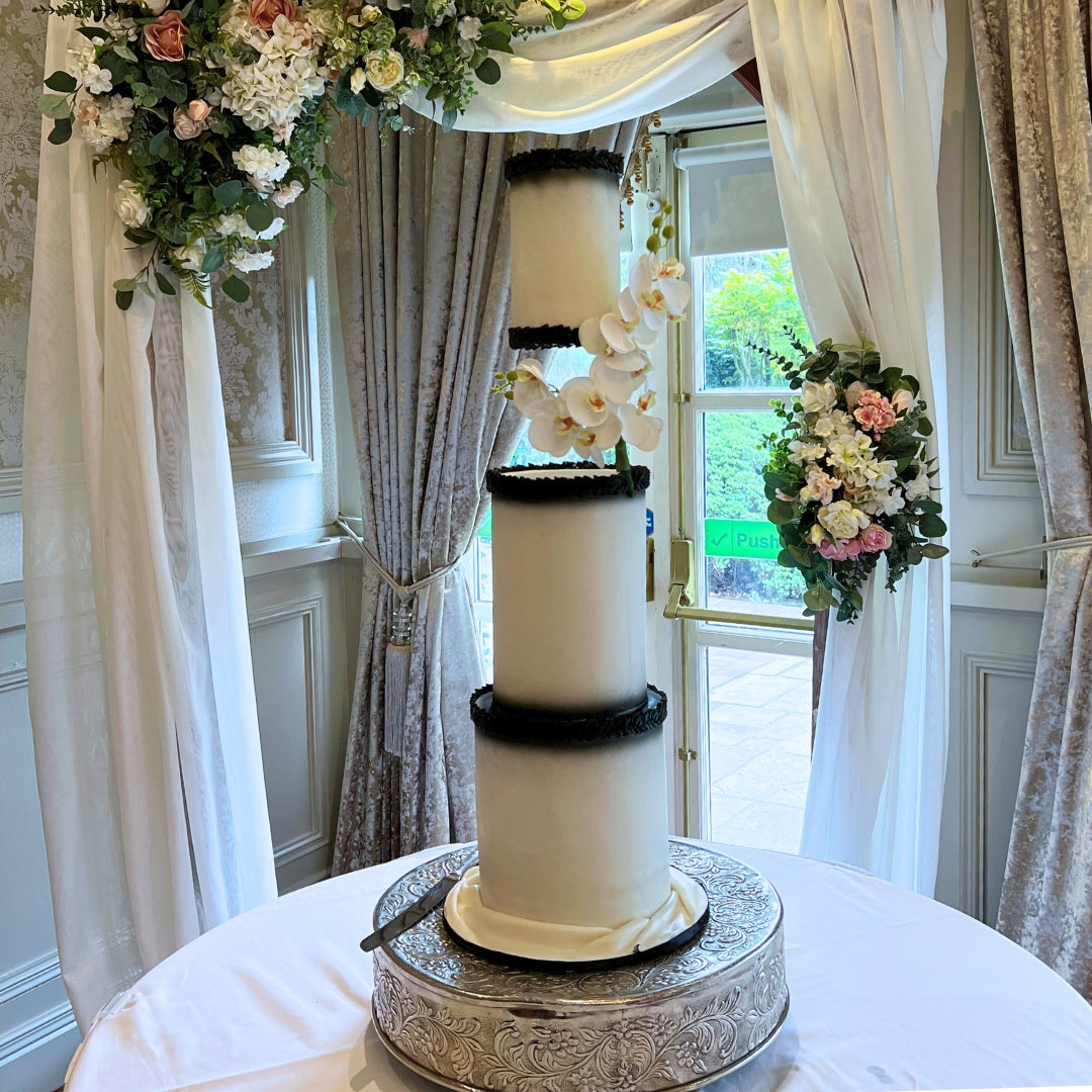 Suspended tier wedding cake with black bead detailing and white orchid cascade on a silver stand, CakeMeAway Dublin