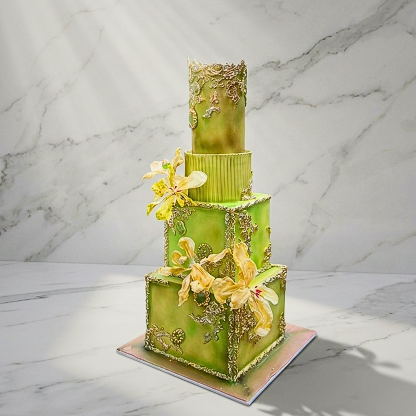 Four tier ornate wedding cake in green and gold with gilded baroque scrollwork and sugar orchids, handmade in Dublin by CakeMeAway