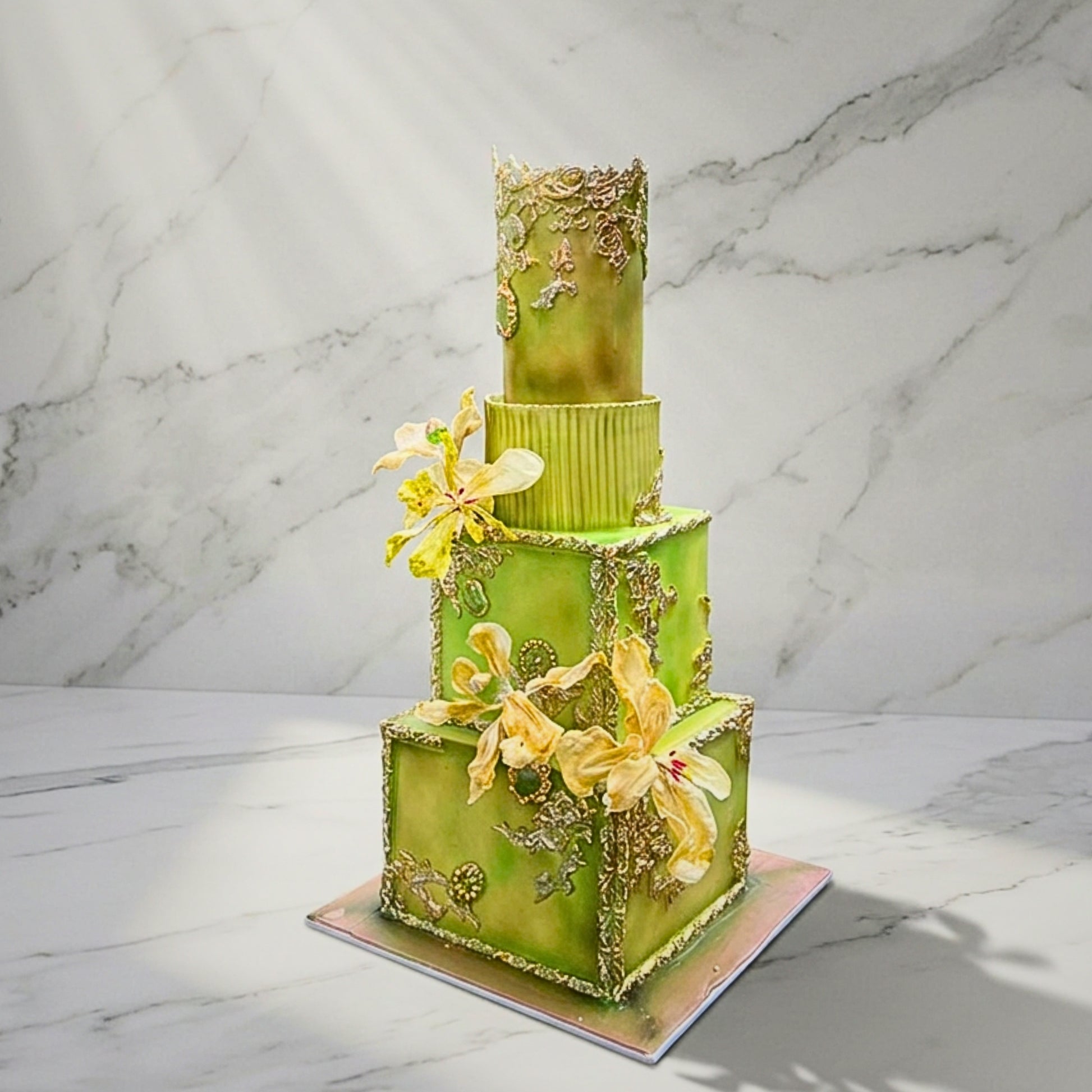 Four tier ornate wedding cake in green and gold with gilded baroque scrollwork and sugar orchids, handmade in Dublin by CakeMeAway