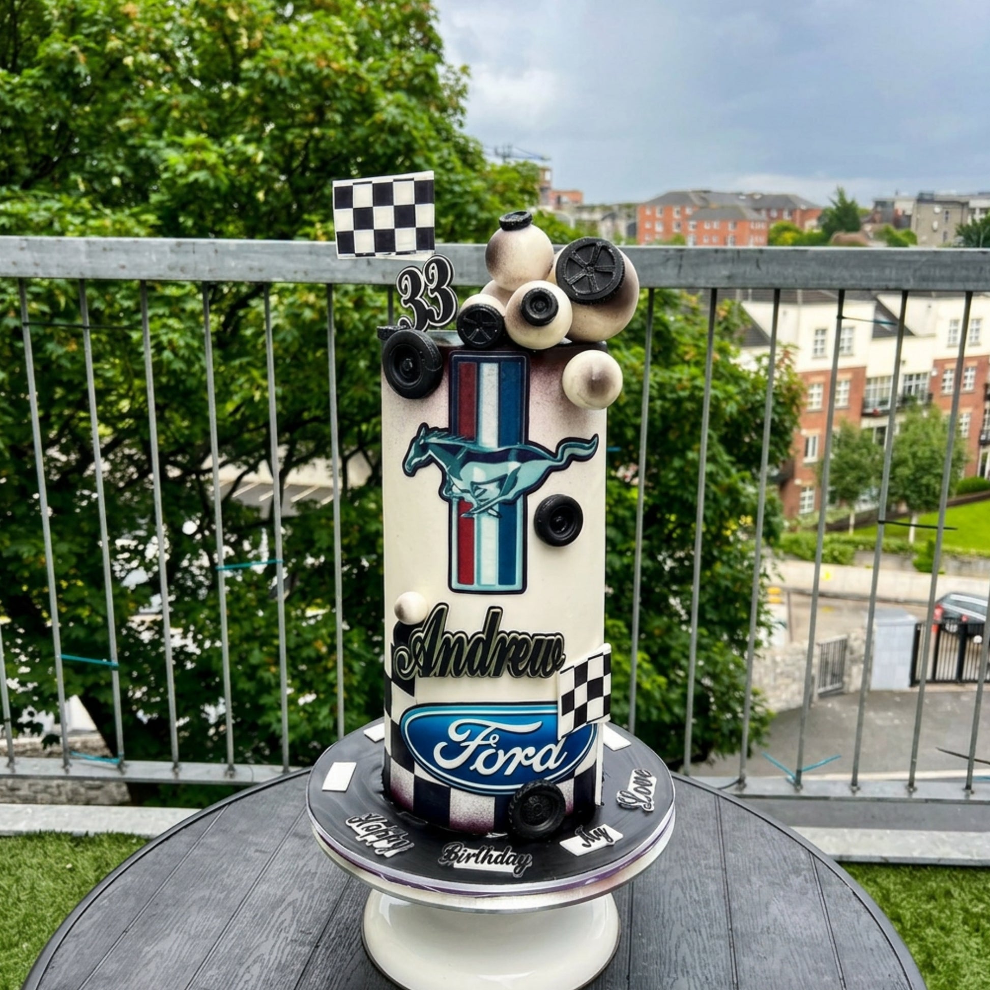 Cream and black classic car birthday cake with chequered flag and sphere cluster for a 33rd birthday, Dublin
