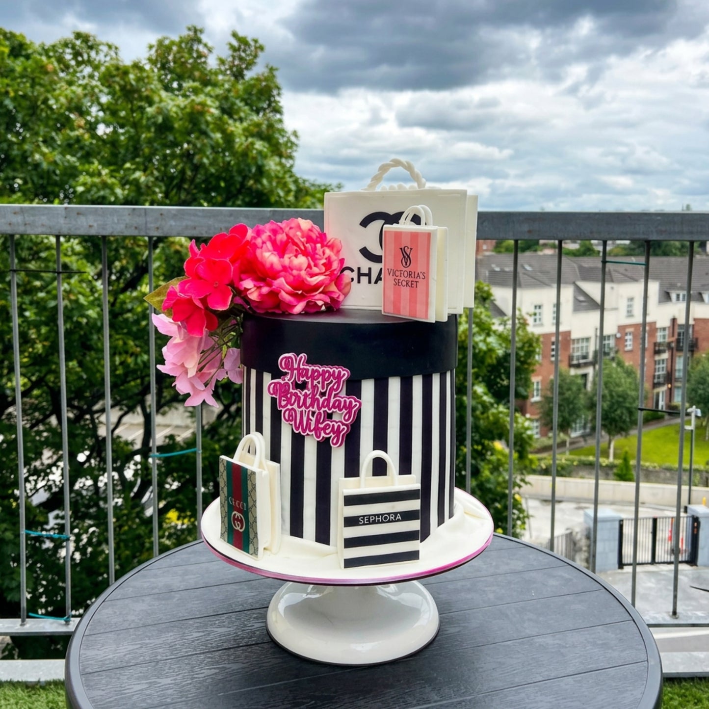 Designer inspired hat box birthday cake with black and white stripes, sculpted shopping bags and pink sugar florals, CakeMeAway Dublin