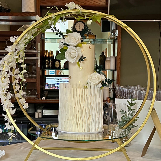 Two tier ivory wedding cake with hand-textured base tier, edible gold leaf and white roses, handmade in Dublin by CakeMeAway