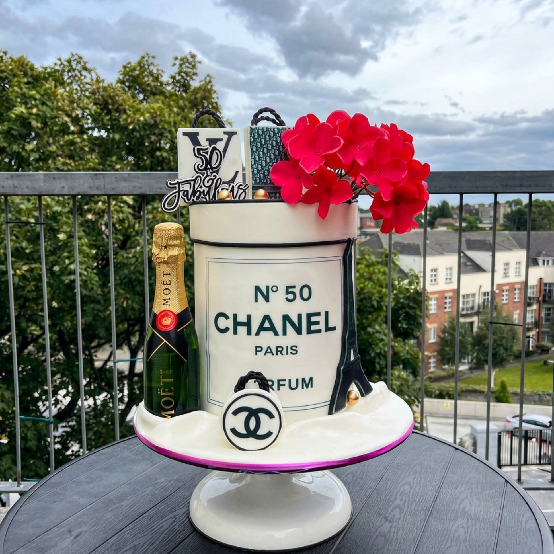 Perfume bottle inspired 50th birthday cake in cream and black with red sugar florals, CakeMeAway Dublin