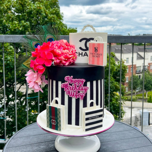 Monochrome striped designer inspired fashion cake with handcrafted shopping bags, peacock feathers and pink peonies, handmade in Dublin by CakeMeAway
