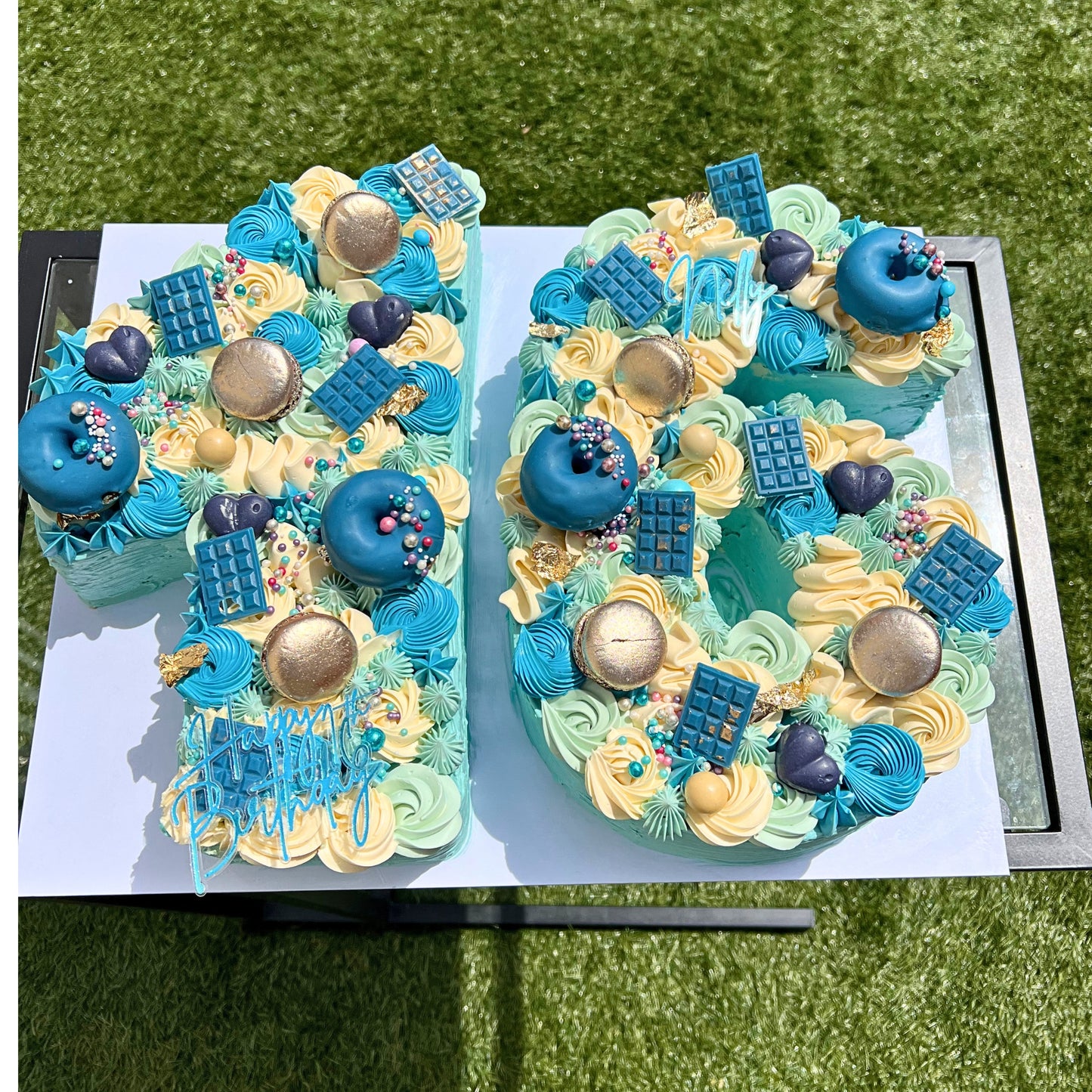 Teal and gold buttercream number cake loaded with donuts, macarons and chocolate pieces, handmade in Dublin by CakeMeAway