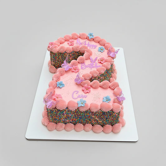 Pink buttercream number cake with piped shells, sprinkle sides, sugar flowers and butterflies, Dublin