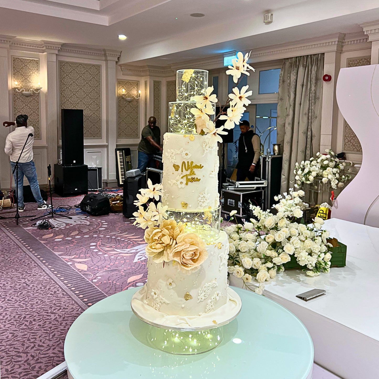 Tall illuminated wedding cake with clear lit tiers and personalised gold name plaque, CakeMeAway Dublin