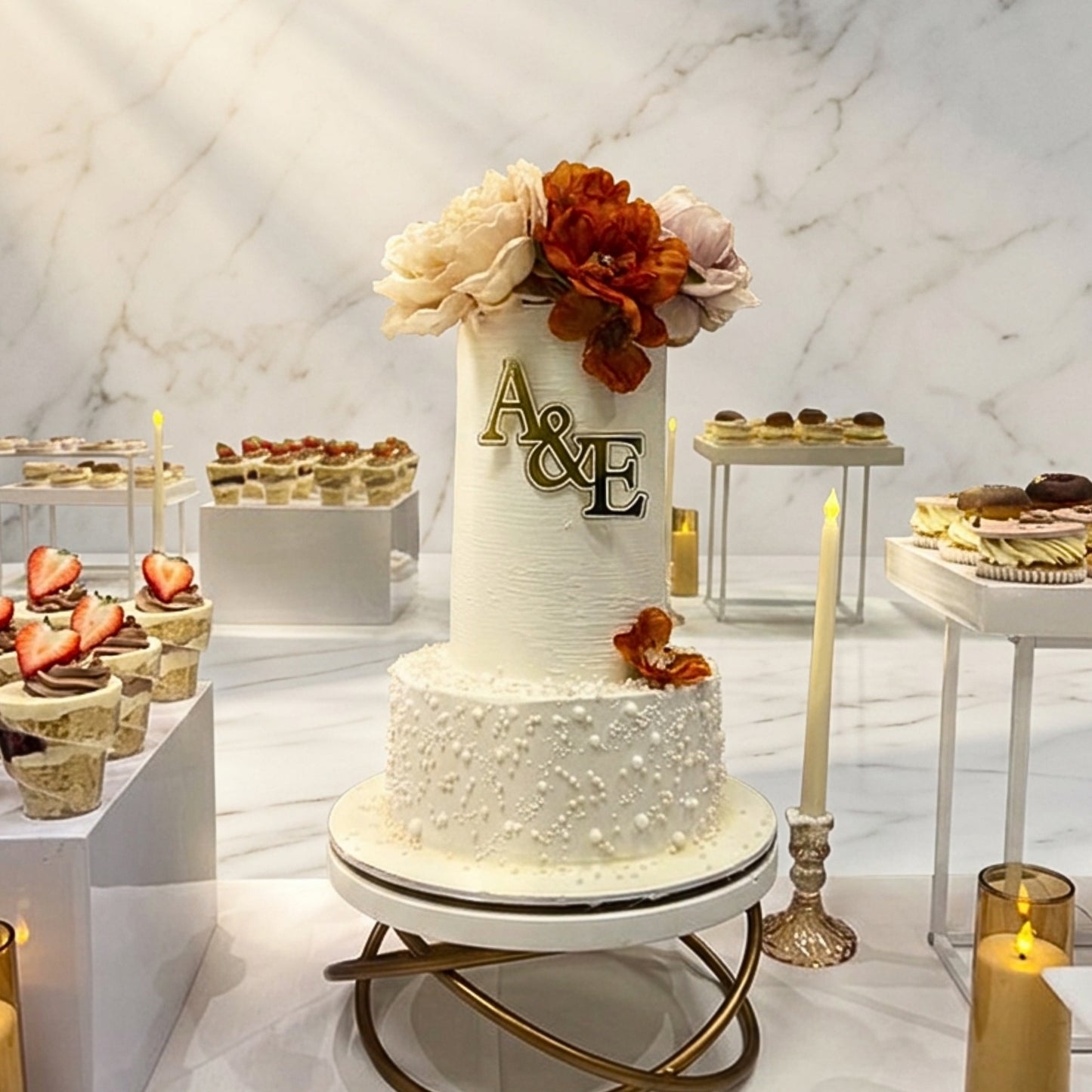 Ivory two tier wedding cake with sugar pearl base tier and gold initial monogram, CakeMeAway Dublin