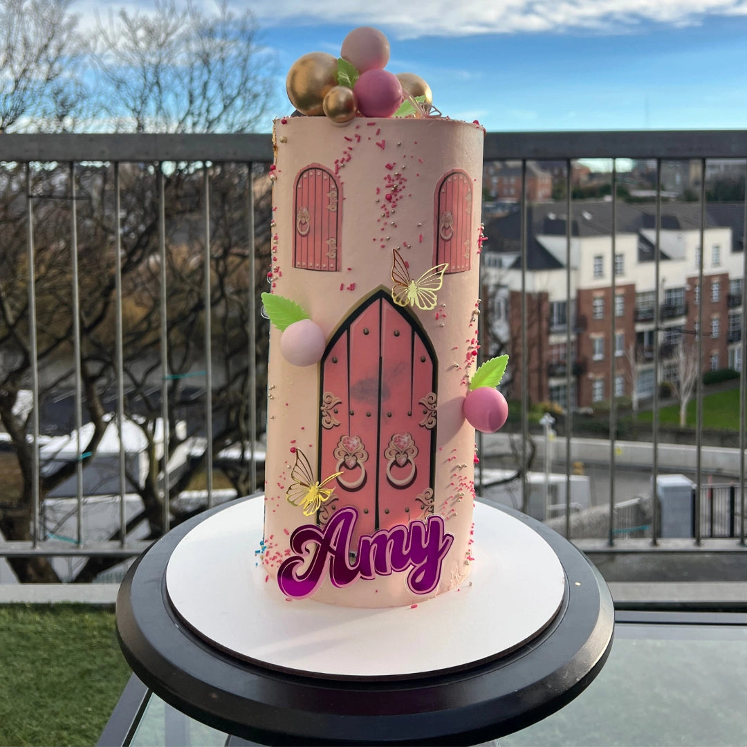 Bespoke double-themed cake showing two different frosting styles and colors for a boy and girl birthday party.