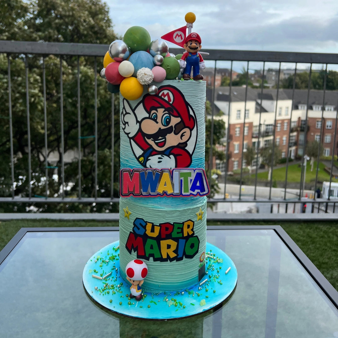 A mario-themed birthday cake with colorful frosting and decorations, including character figurines and balloons.