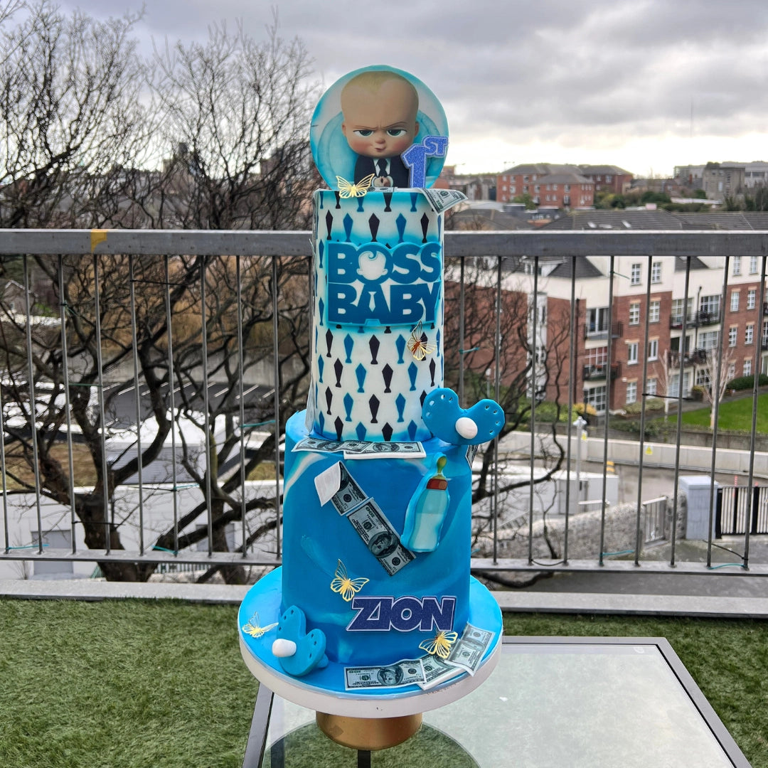 Close-up of a DOUBLE TIERED designer 'Little Boss' celebration cake featuring a sharp suit aesthetic and gold-dusted accents.