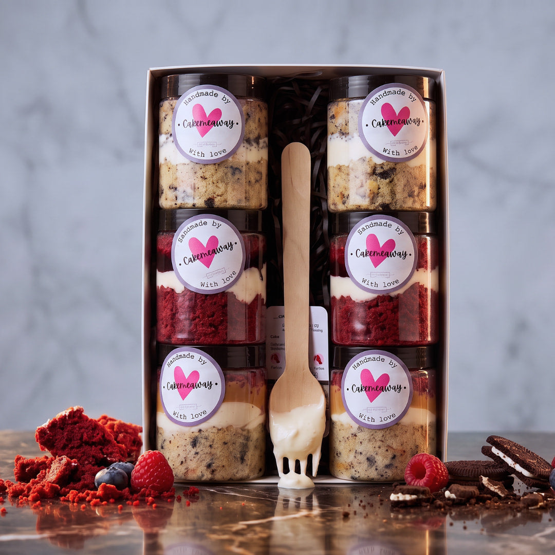 Gift box of 6 cake jars with red velvet, cookies and cream and caramel layers and pink heart labels, handmade in Dublin by CakeMeAway
