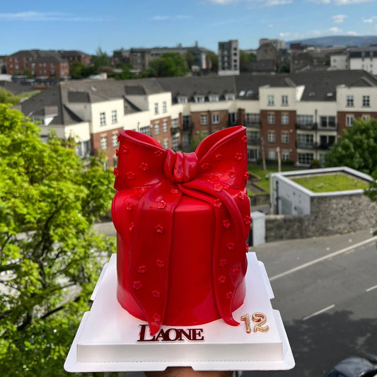 RED CAKE WITH A RED BOW