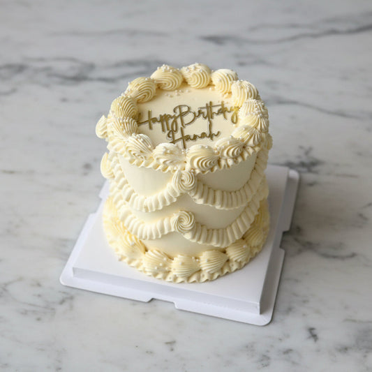 birthday cake with 'Happy Birthday Hannah' on a marble surface