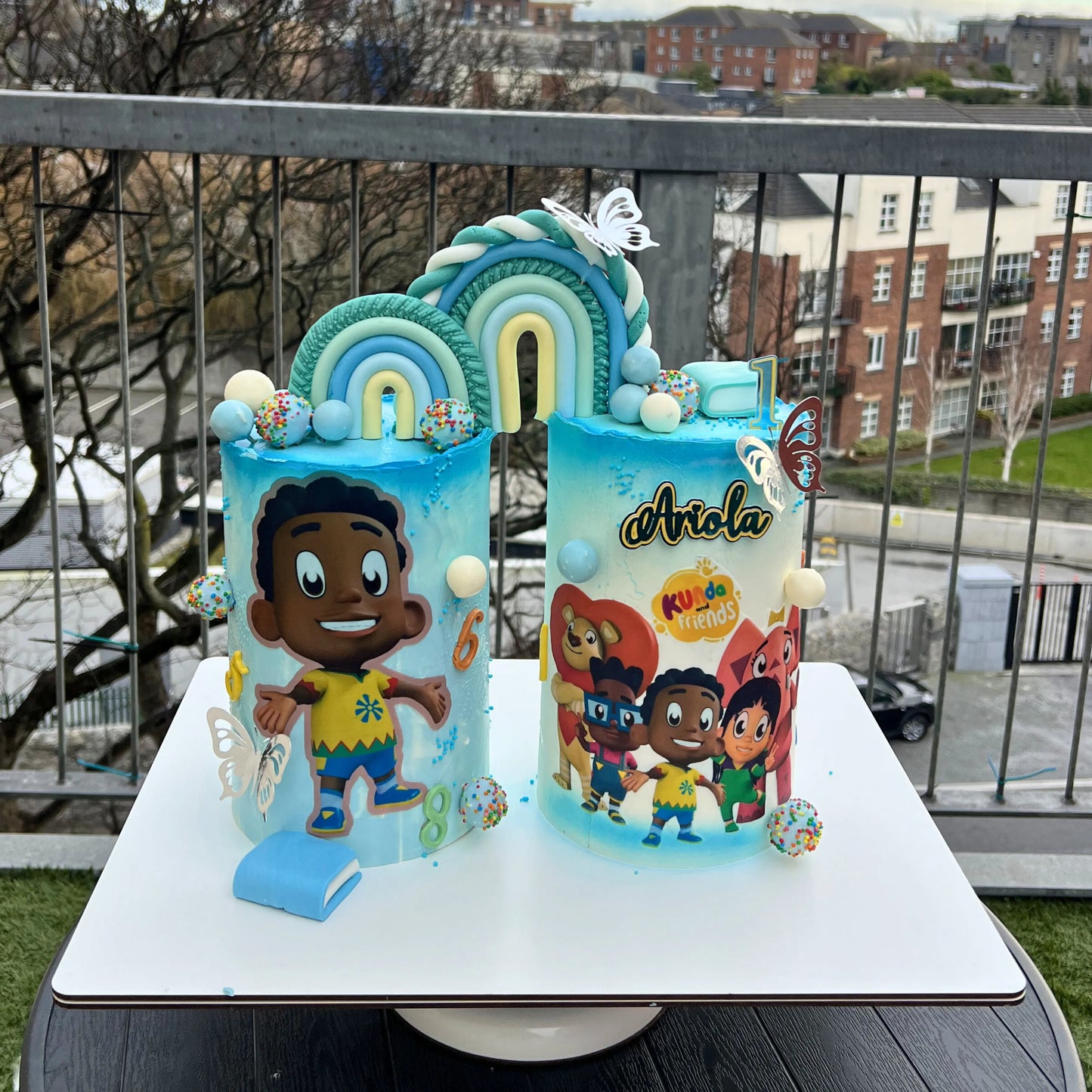 Two colourful birthday cakes with Black cartoon character artwork on one board, Dublin