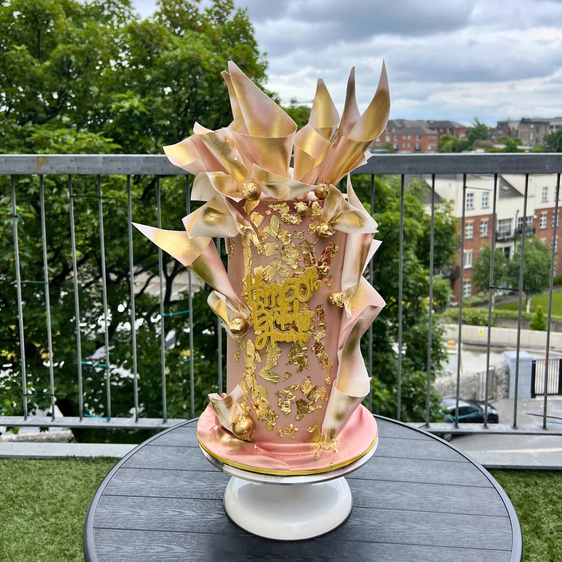 Decorative vase with gold and beige wafer paper  design on a table outdoors