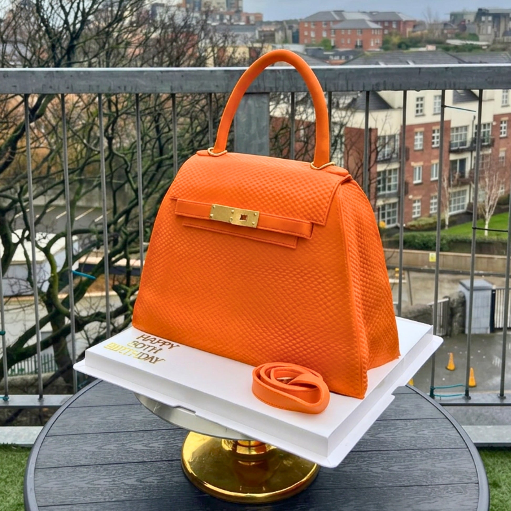 Blue designer bag cake with a personalised name plaque, handmade in Dublin