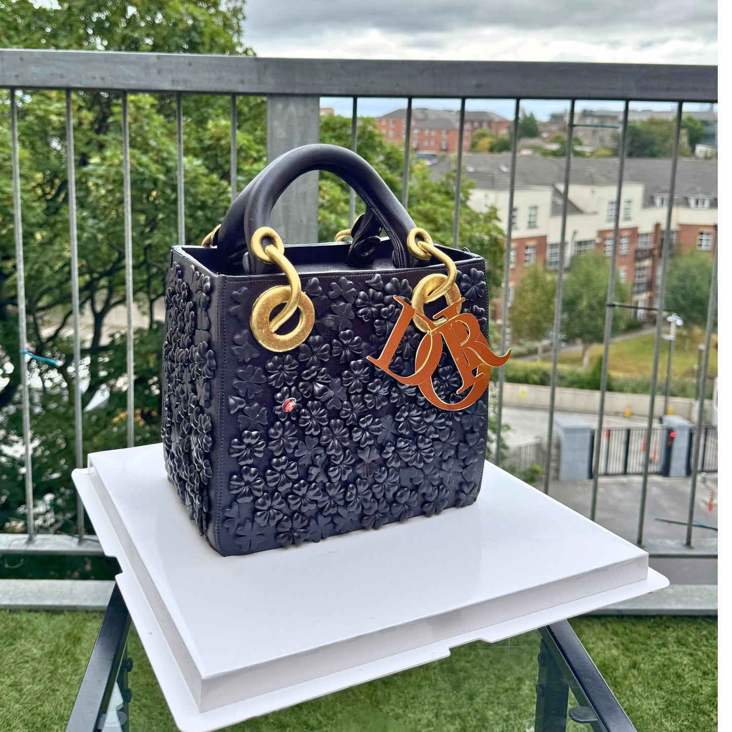 Black quilted designer handbag cake with personalised letter charms by CakeMeAway
