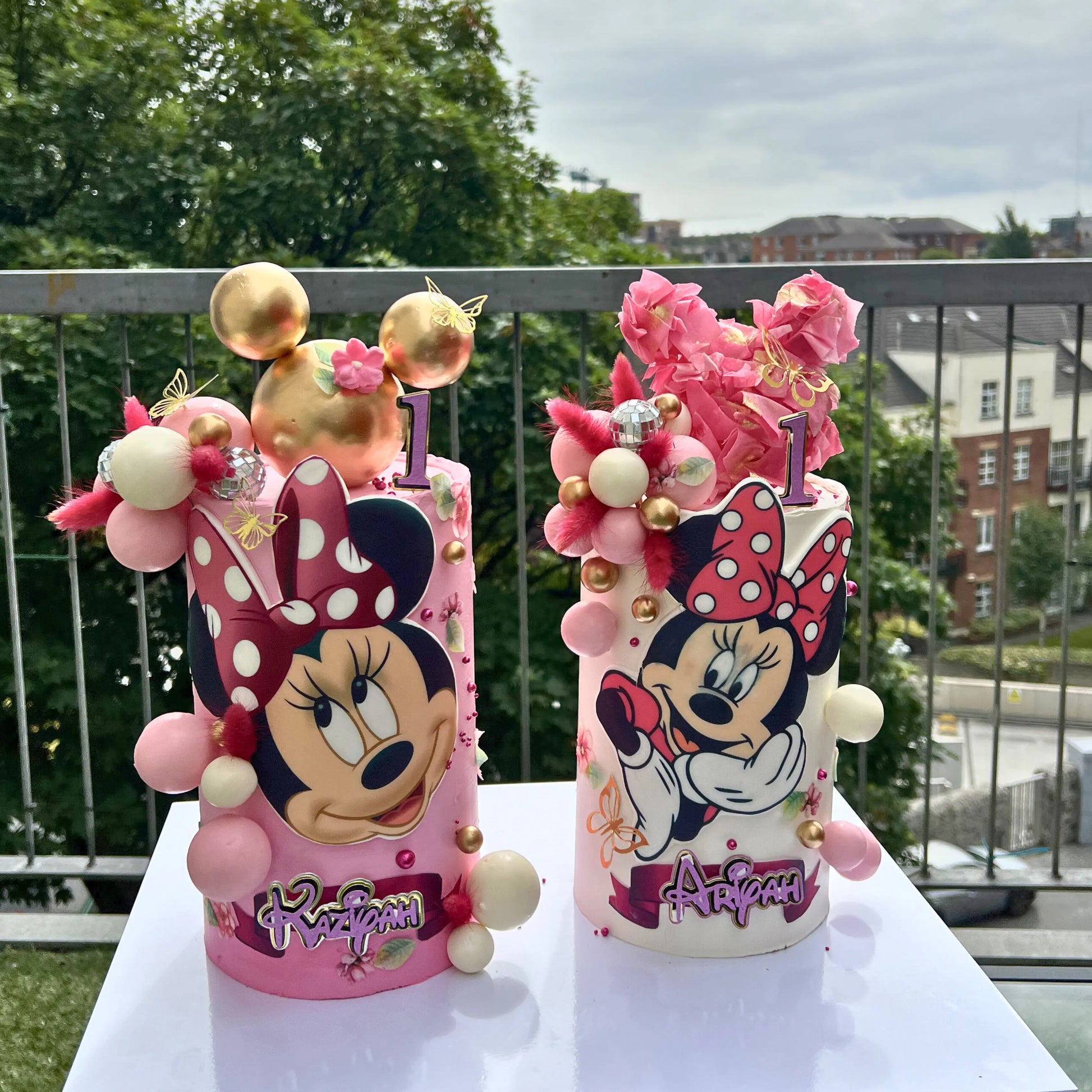 Pink double cake set with character panels and gold sphere garland, CakeMeAway Dublin