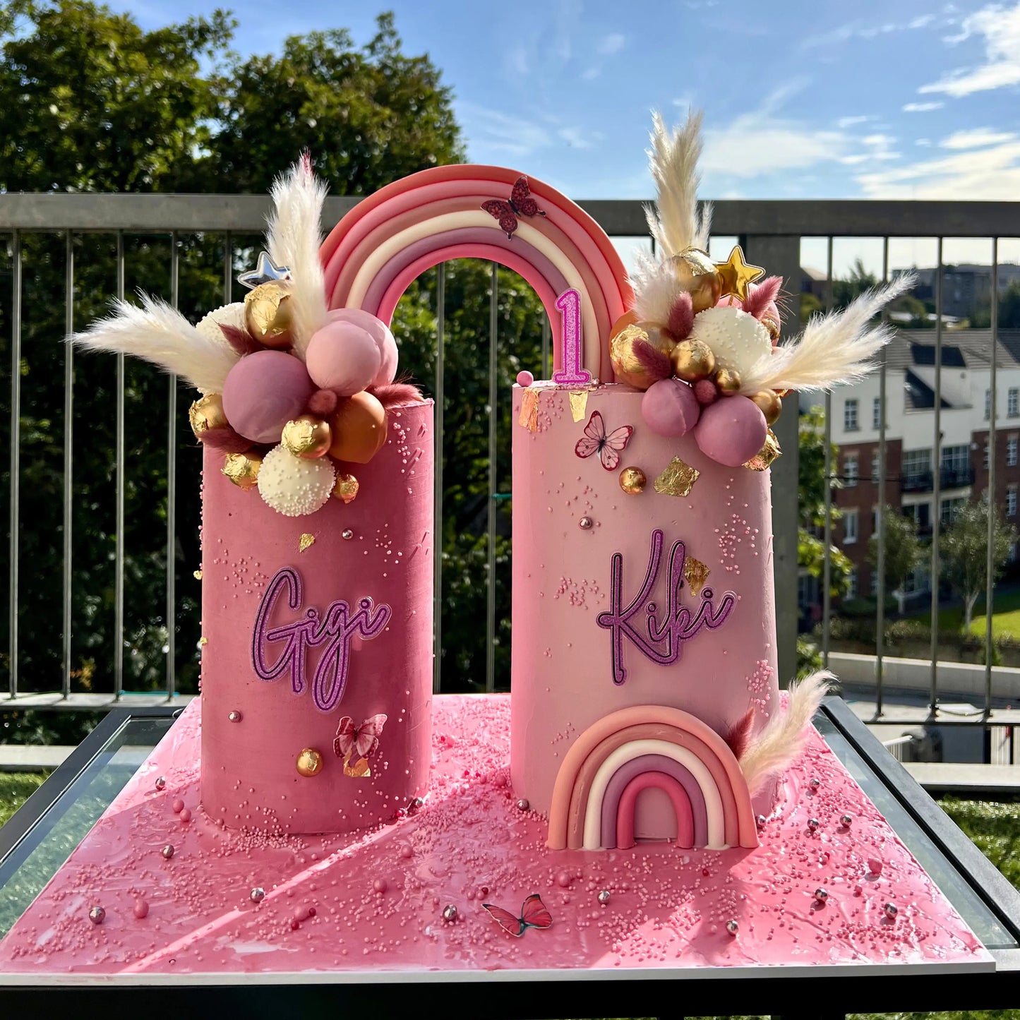 Whimsical pink double cake set with rainbow arch and sphere detailing, Dublin