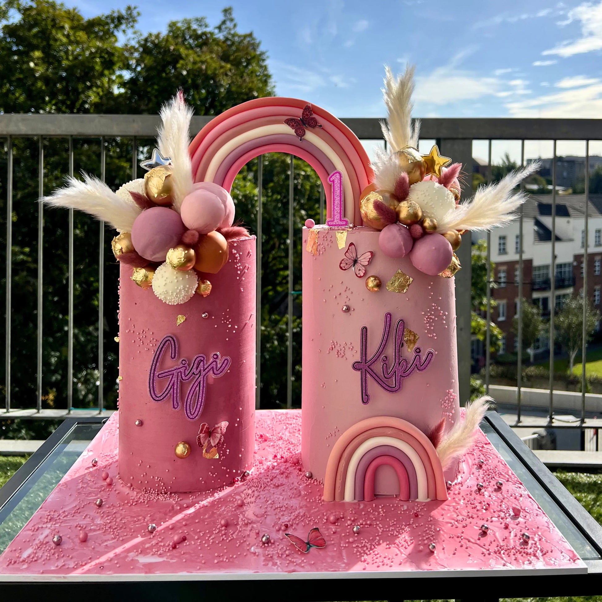Whimsical pink double cake set with rainbow arch and sphere detailing, Dublin