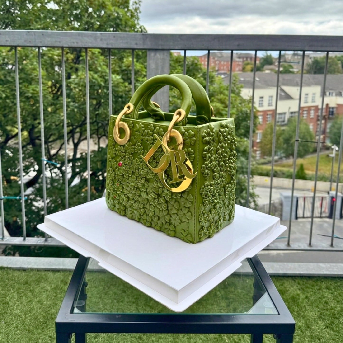 Diamond-quilted texture and rolled top handles on a black designer handbag cake